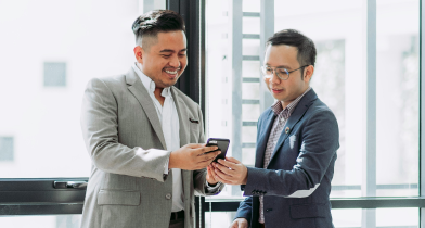 Top people smiling looking at a phone